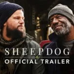 A photo of a mid-30's white male veteran sitting on the back og a truck with an older african american vietnam veteran smiling in work clothes and winter coats.