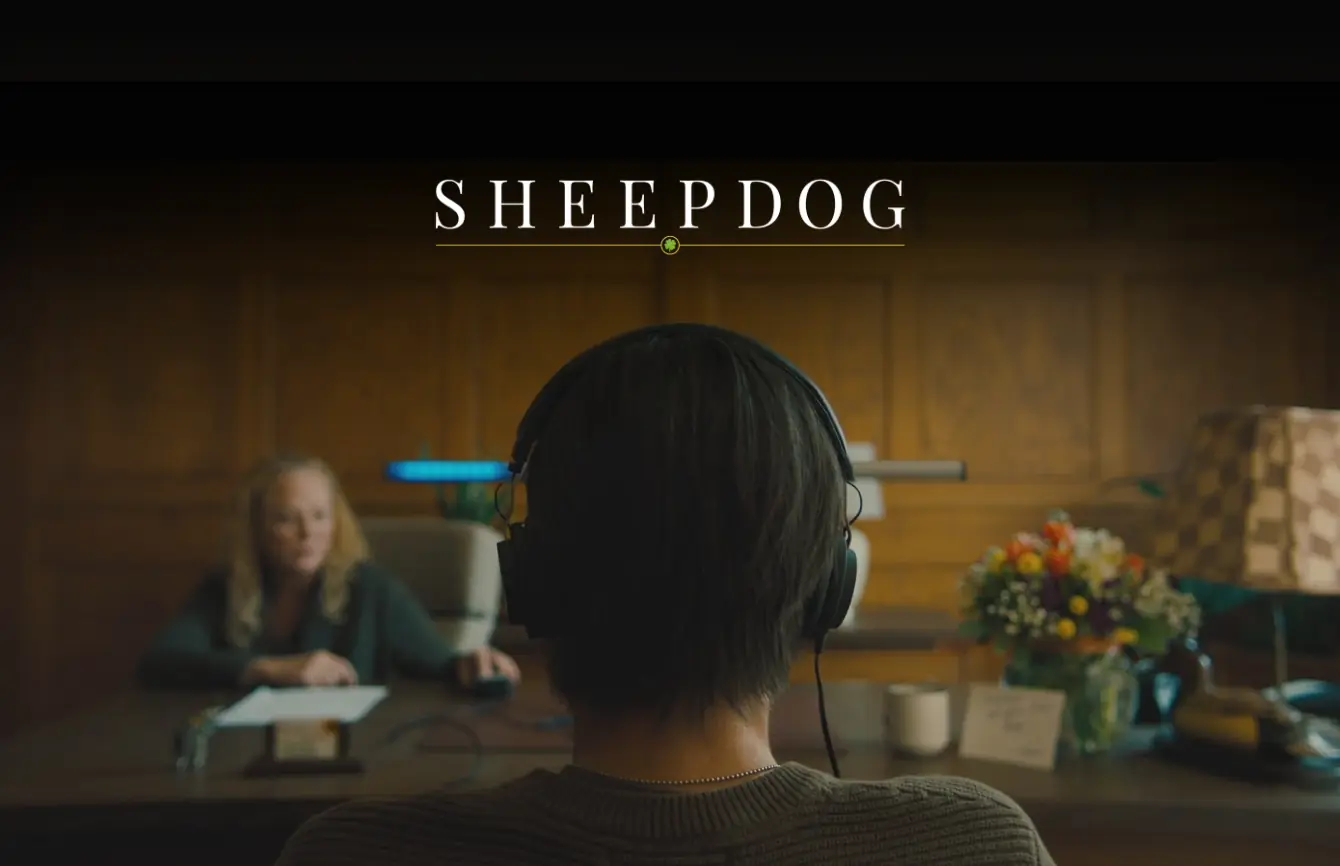 A person wearing headphones sits in a therapy session across from a clinician, with the title Sheepdog displayed above, symbolizing healing and growth after trauma.
