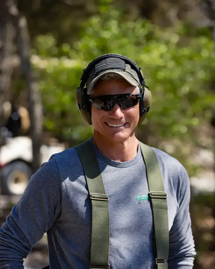 Participant at a Warriors’ Ascent clay shoot fundraiser wearing hearing protection, representing community support for veteran and first responder mental health programs